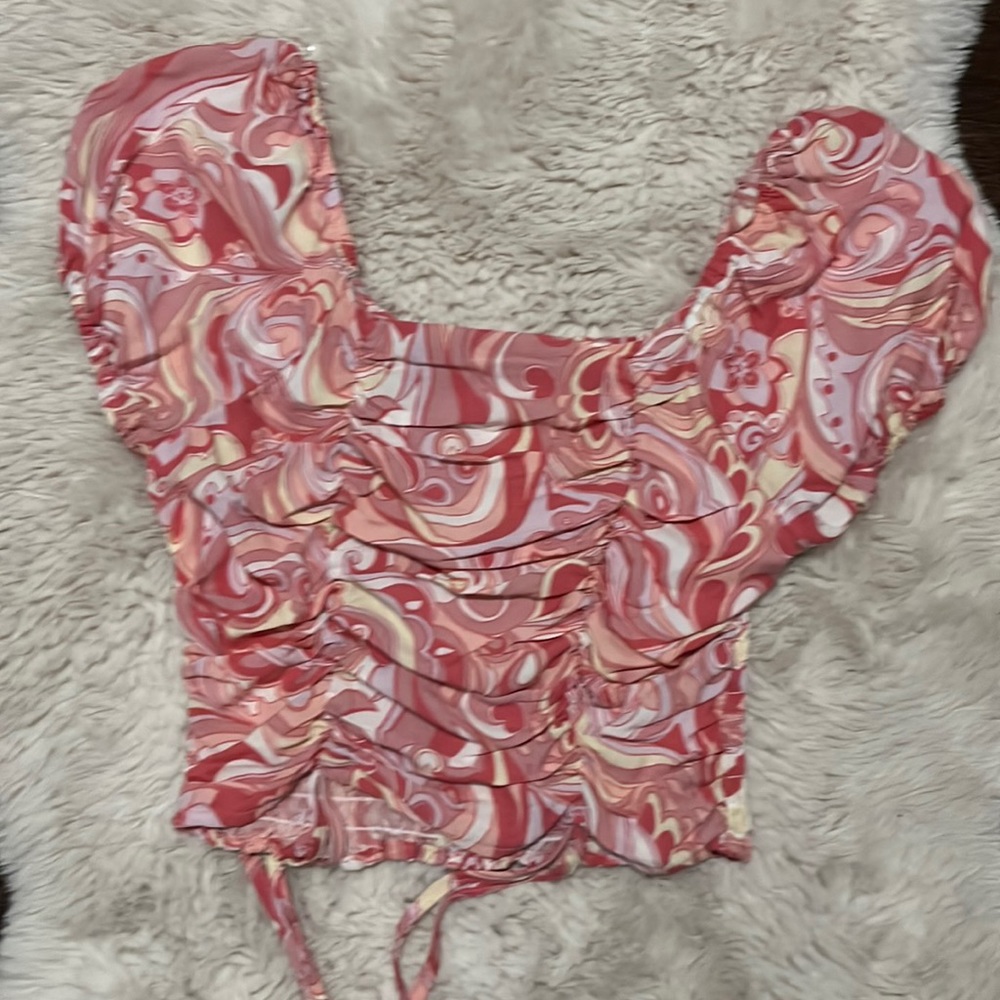 Cropped pink marble shirt.